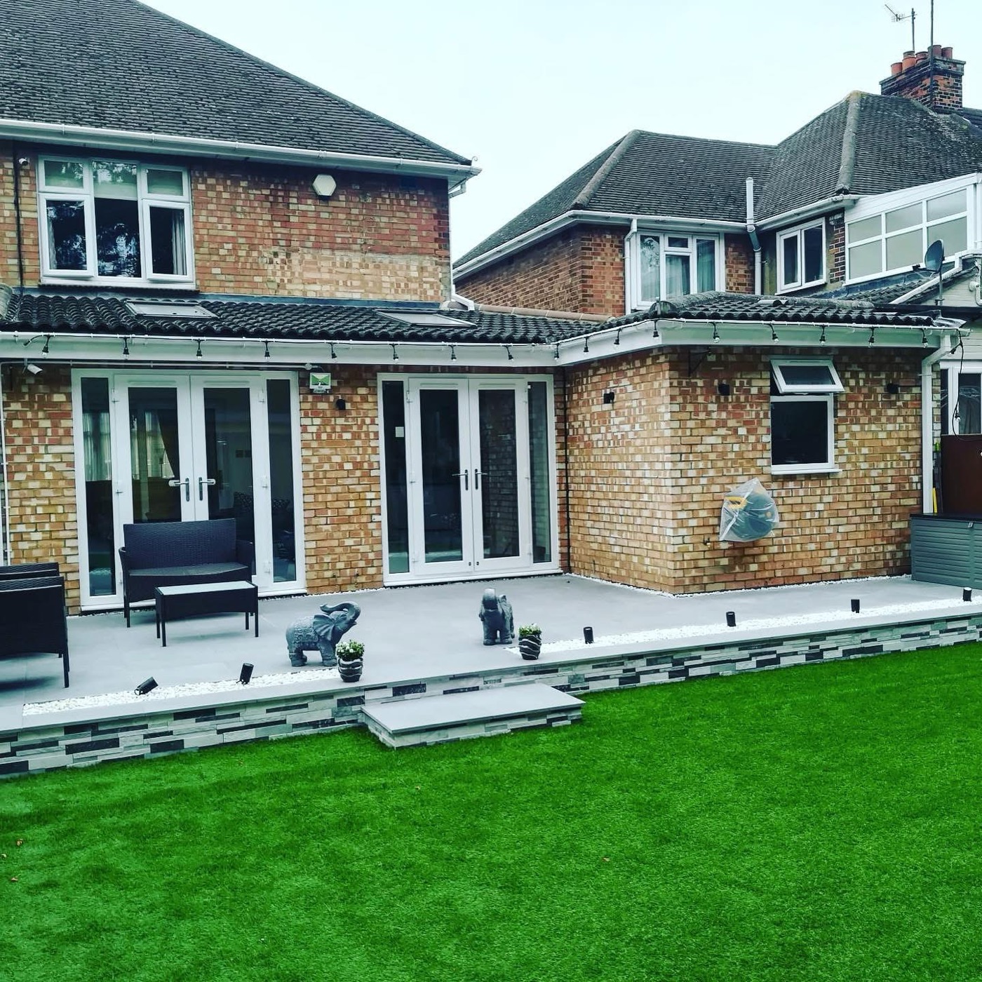 Finished garden with new patio, artificial lawn and extension